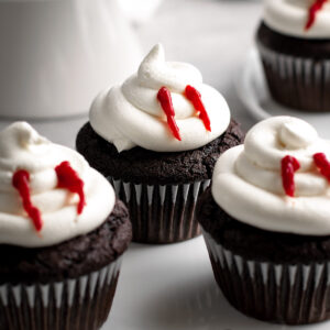 vampire bite cupcakes on a white plate.