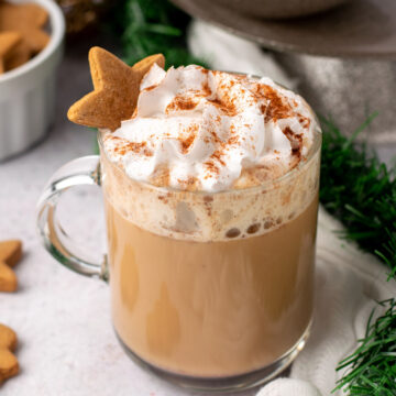 healthy gingerbread latte with whipped cream and a gingerbread cookie