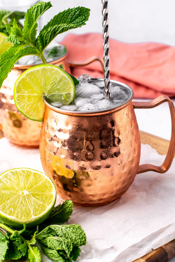 stirring a moscow mule in a copper cup