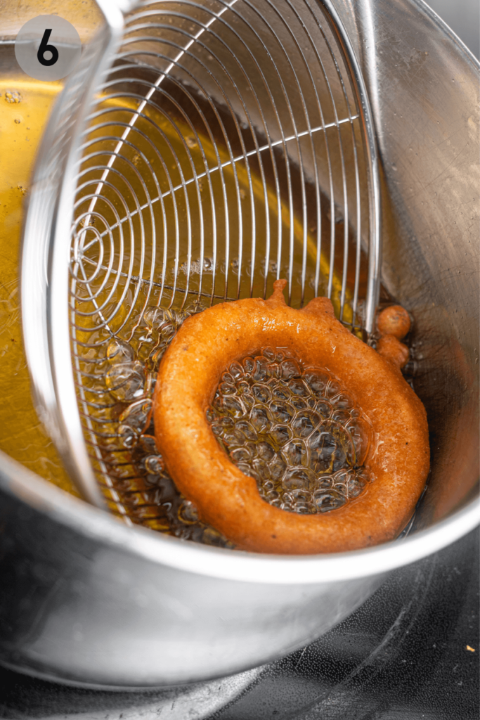 onion ring being scooped out of oil