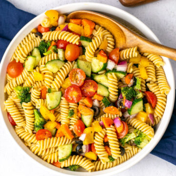 a wood spoon scooping pasta salad