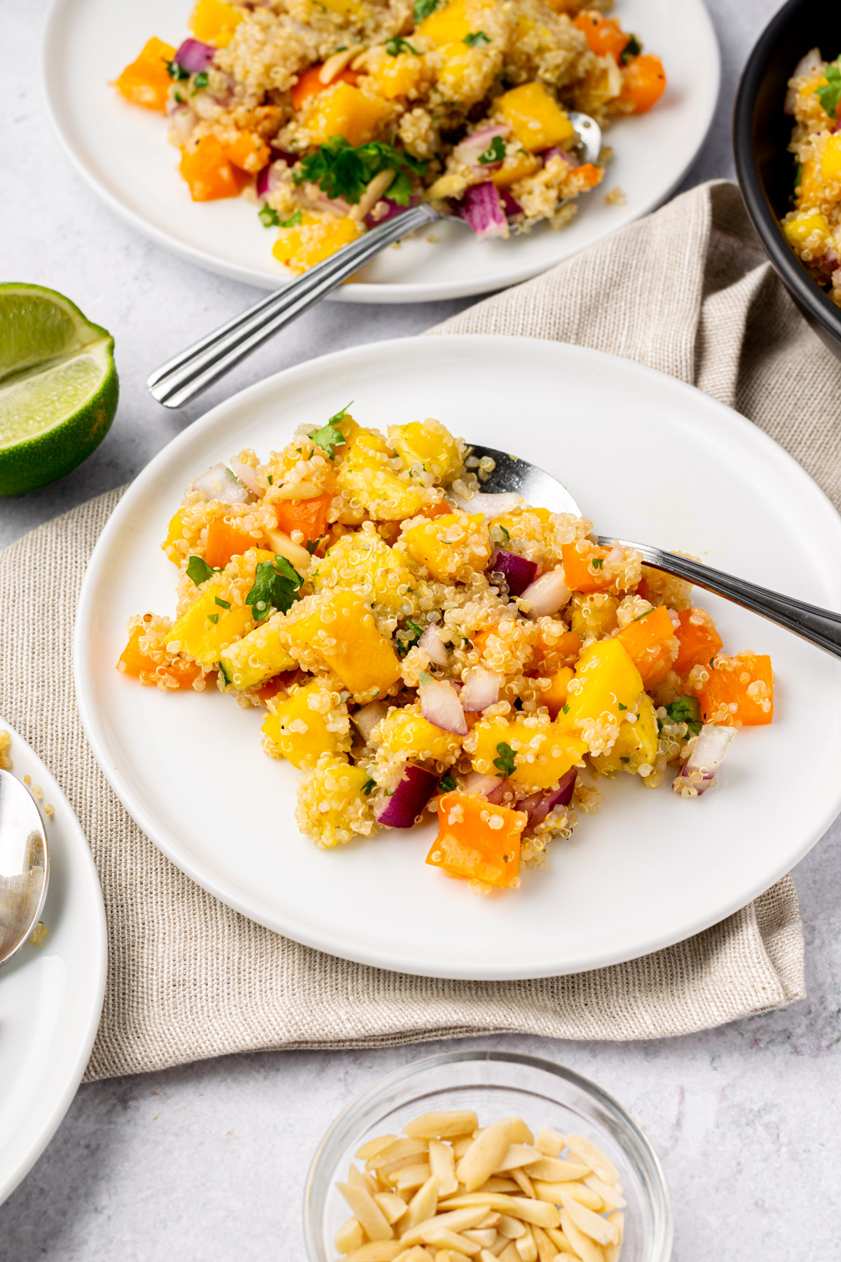 mango pineapple quinoa salad on small serving plates