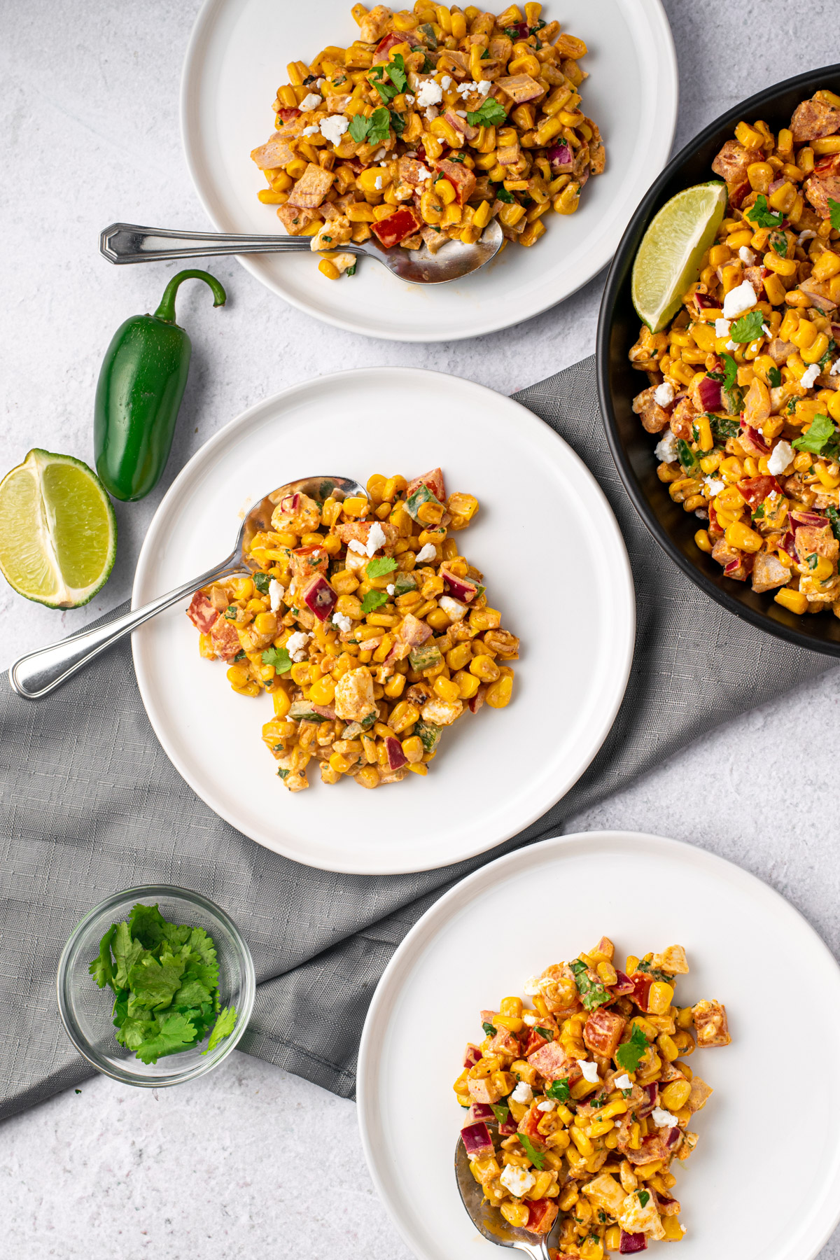 mexican street corn on 3 white plates