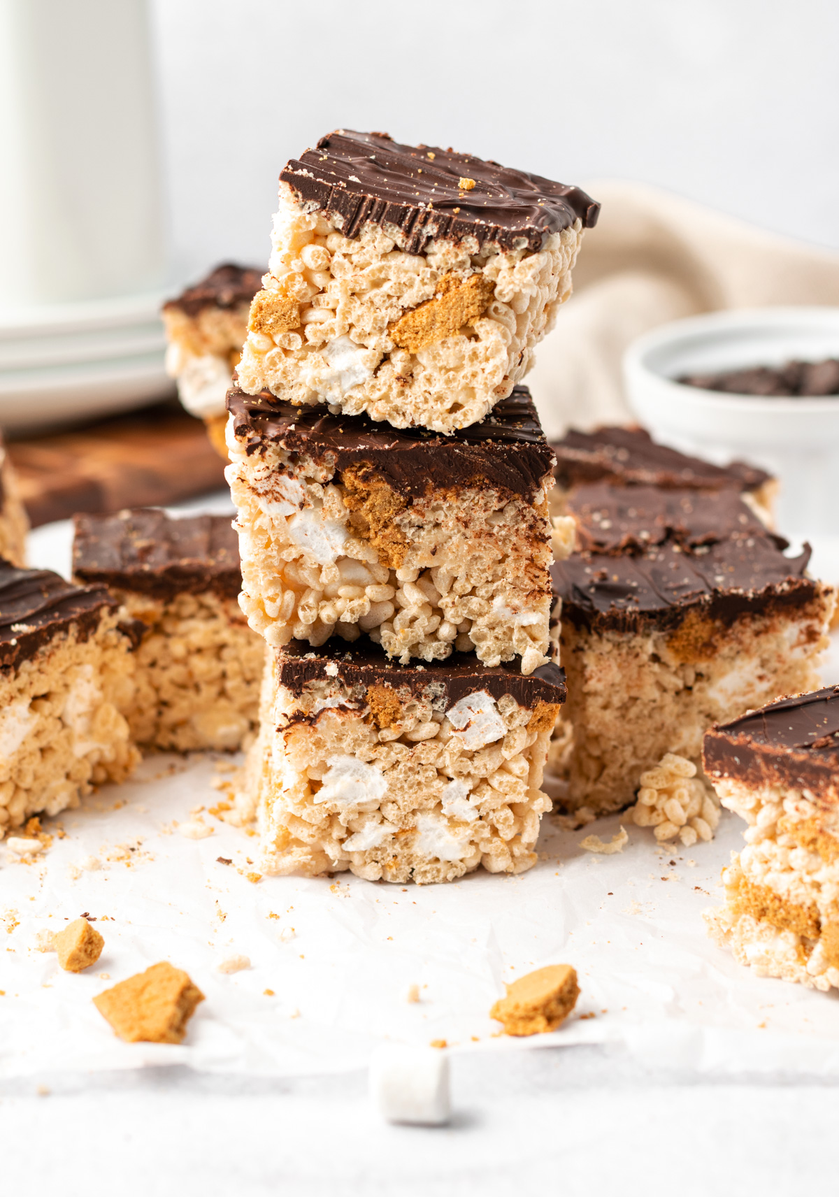 3 s'mores rice crispy treats sliced into square bars and stacked on top of eachother
