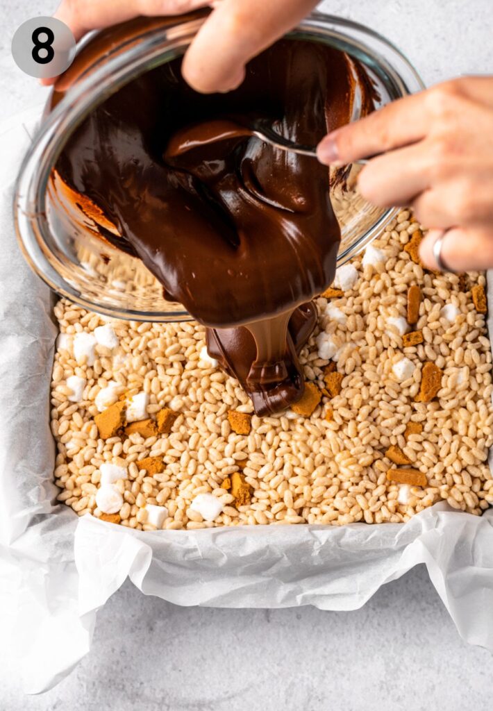 melted chocolate being poured onto s'mores rice crispy treats