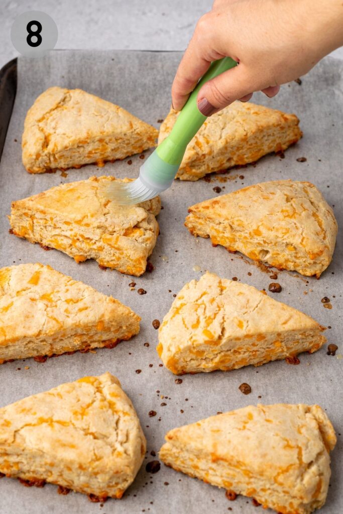 cheese scones being brushed with butter