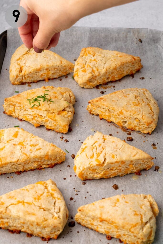 gluten free cheese scones being sprinkled with chives