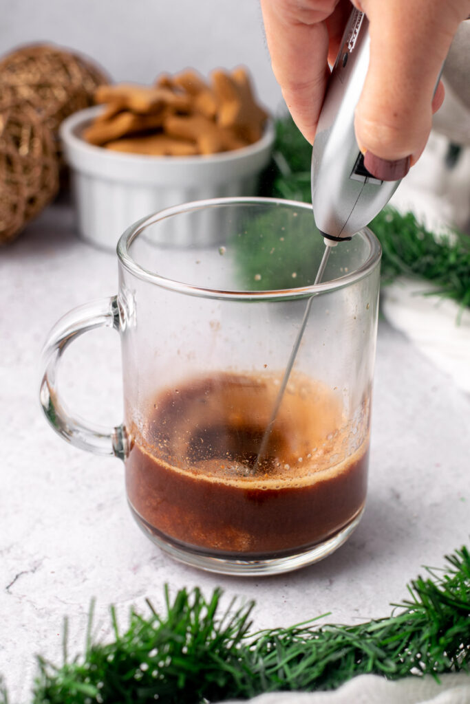 whisking gingerbread latte syrup in a mug
