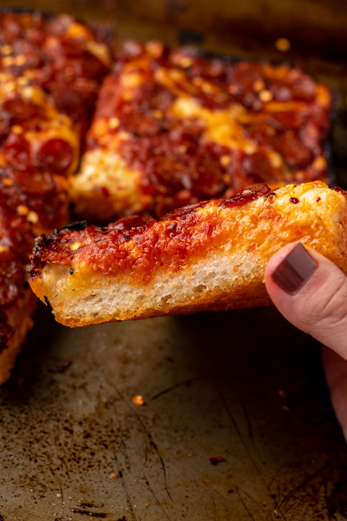 side view of the fluffy detroit style pizza crust