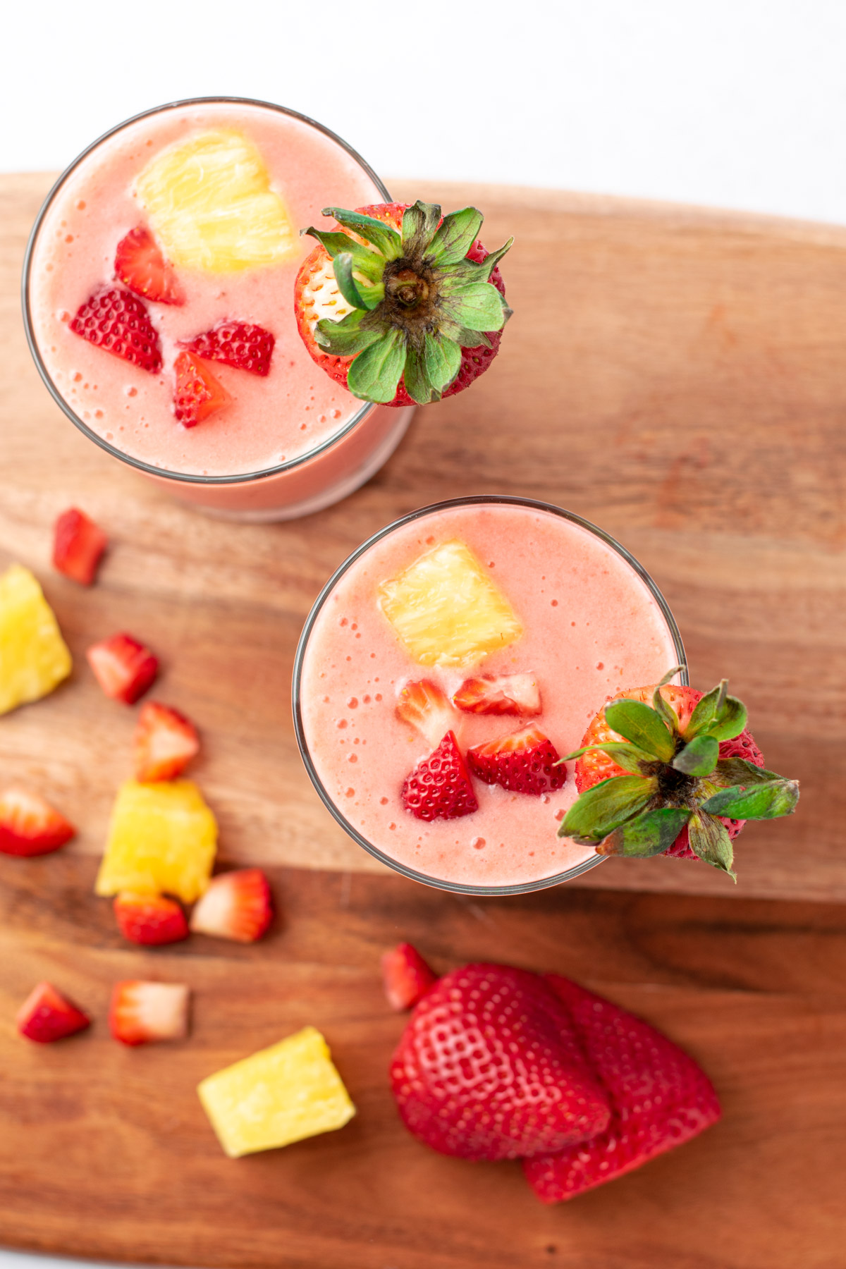 top view of pink strawberry pineapple smoothies