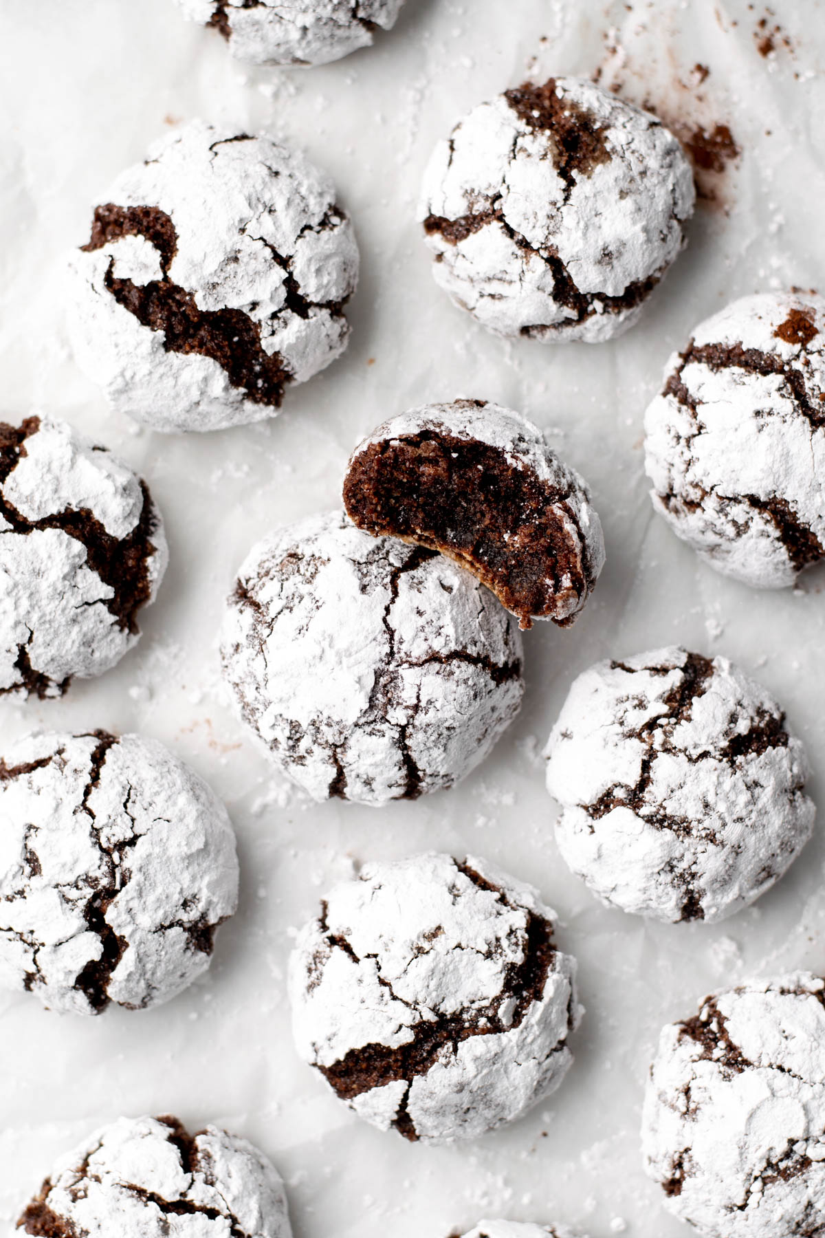 chocolate amaretti cookies with one with a bite taken out of it.