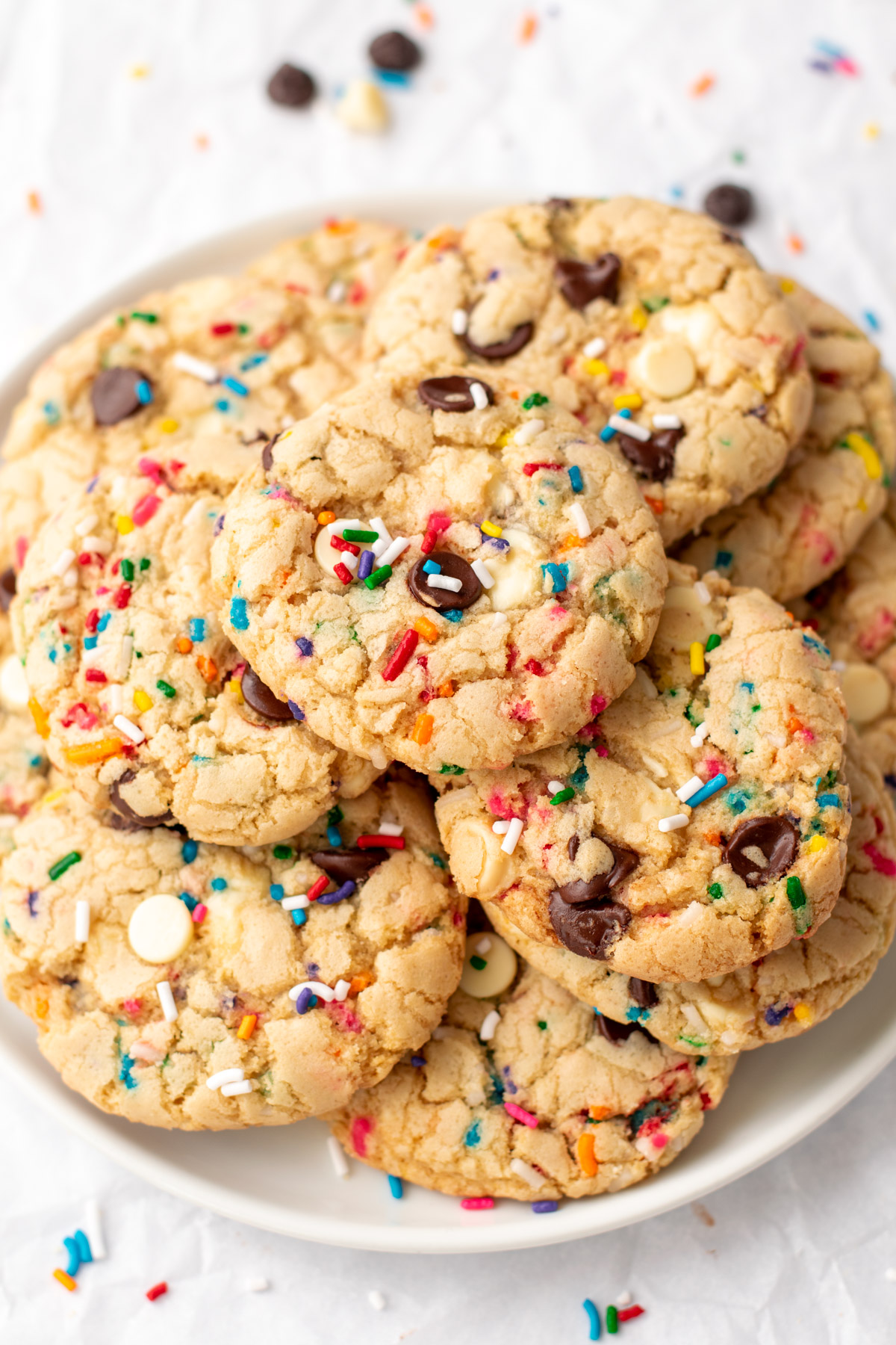 funfetti cookies stacked on a white plate