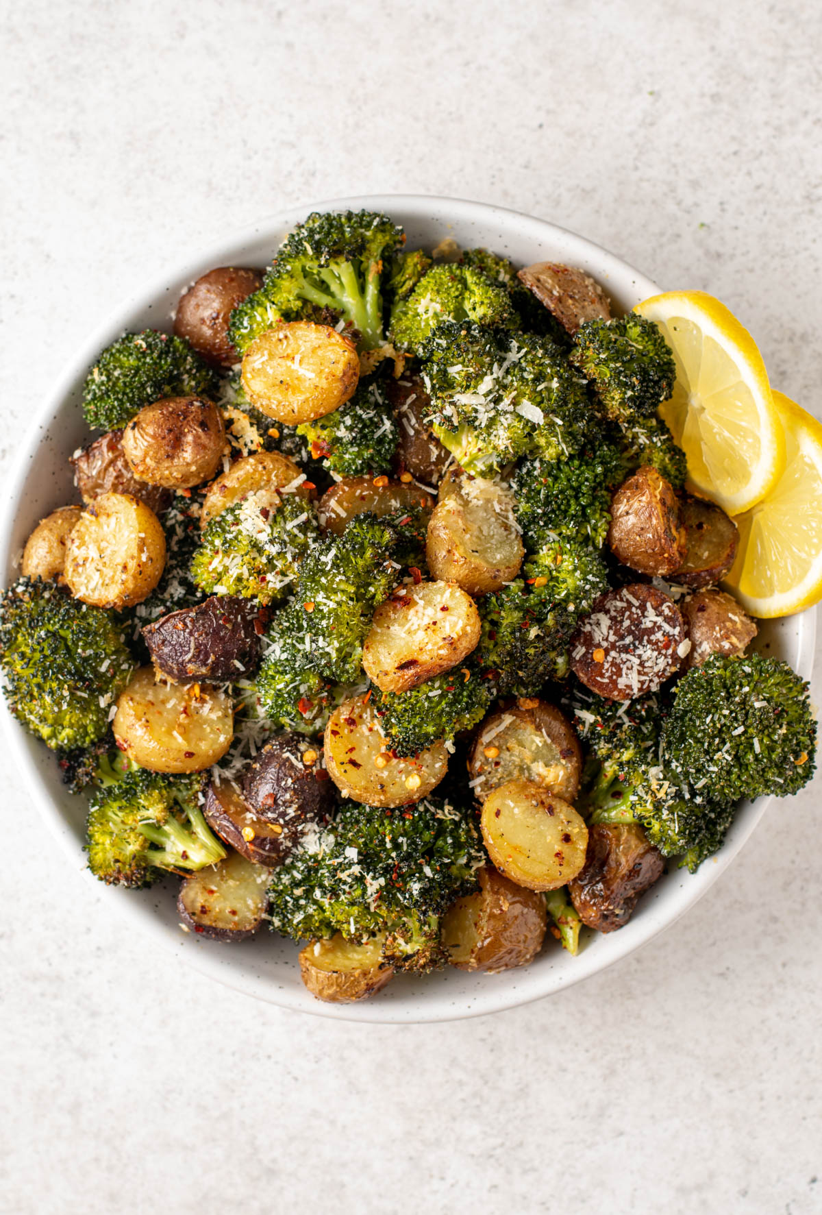 top view of roasted potatoes and broccoli in a bowl.