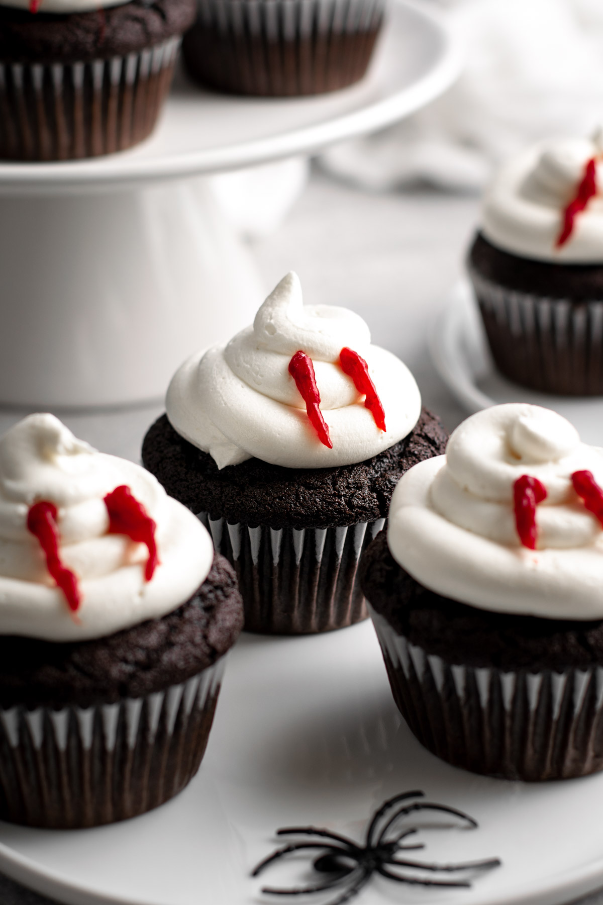 vampire bite cupcakes on a white plate.