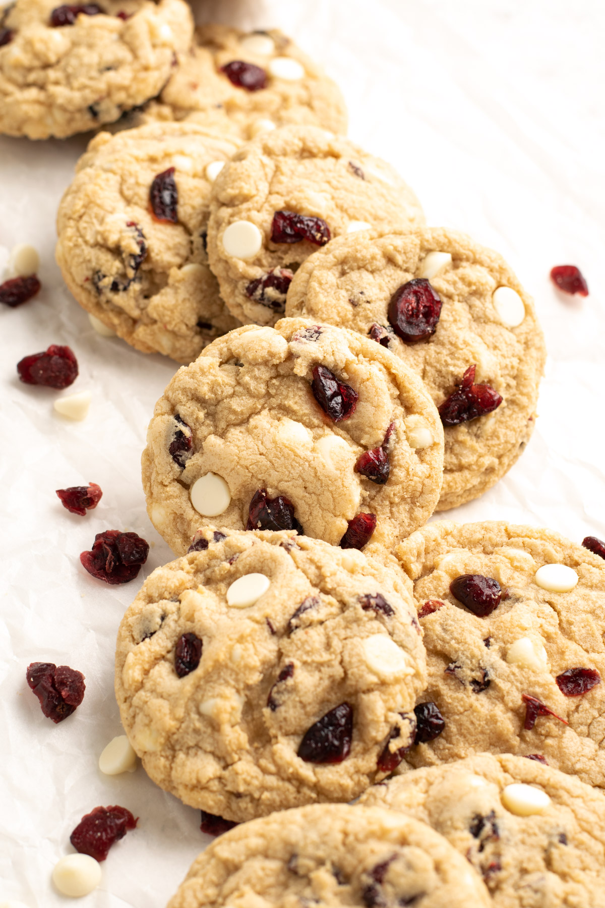 gluten free white chocolate cranberry cookies lined up on parchment paper.
