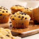 close up of gluten free chocolate chip muffin with more in the background.