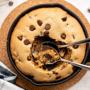 2 spoons in a hole in a mini skillet cookie.