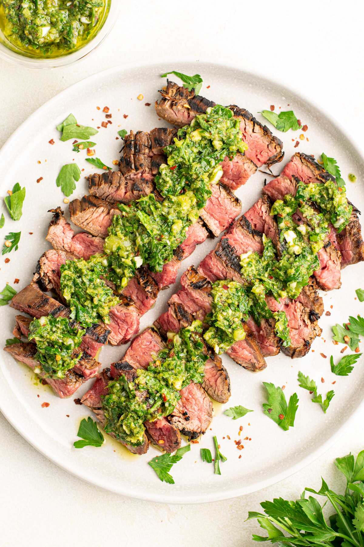 top view of sliced steak with chimichurri on top.