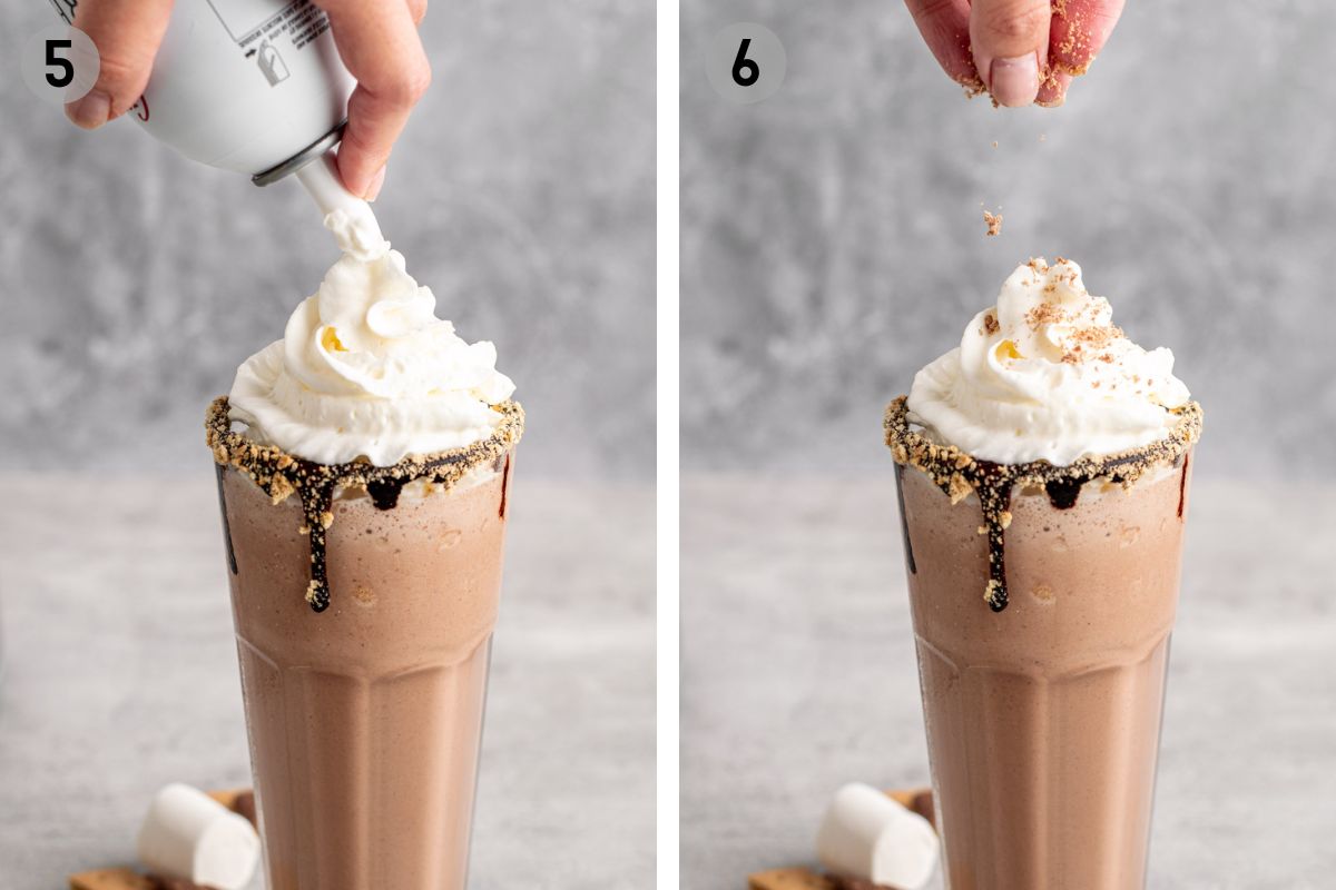 hand topping a s'mores milkshake with whipped cream then crushed graham crackers.