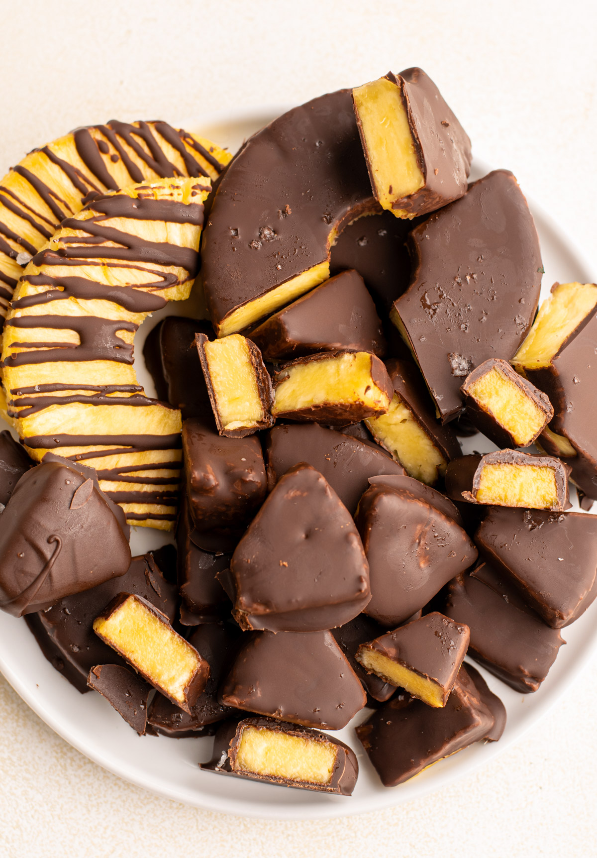 top view of chocolate covered pineapple pieces on a plate.