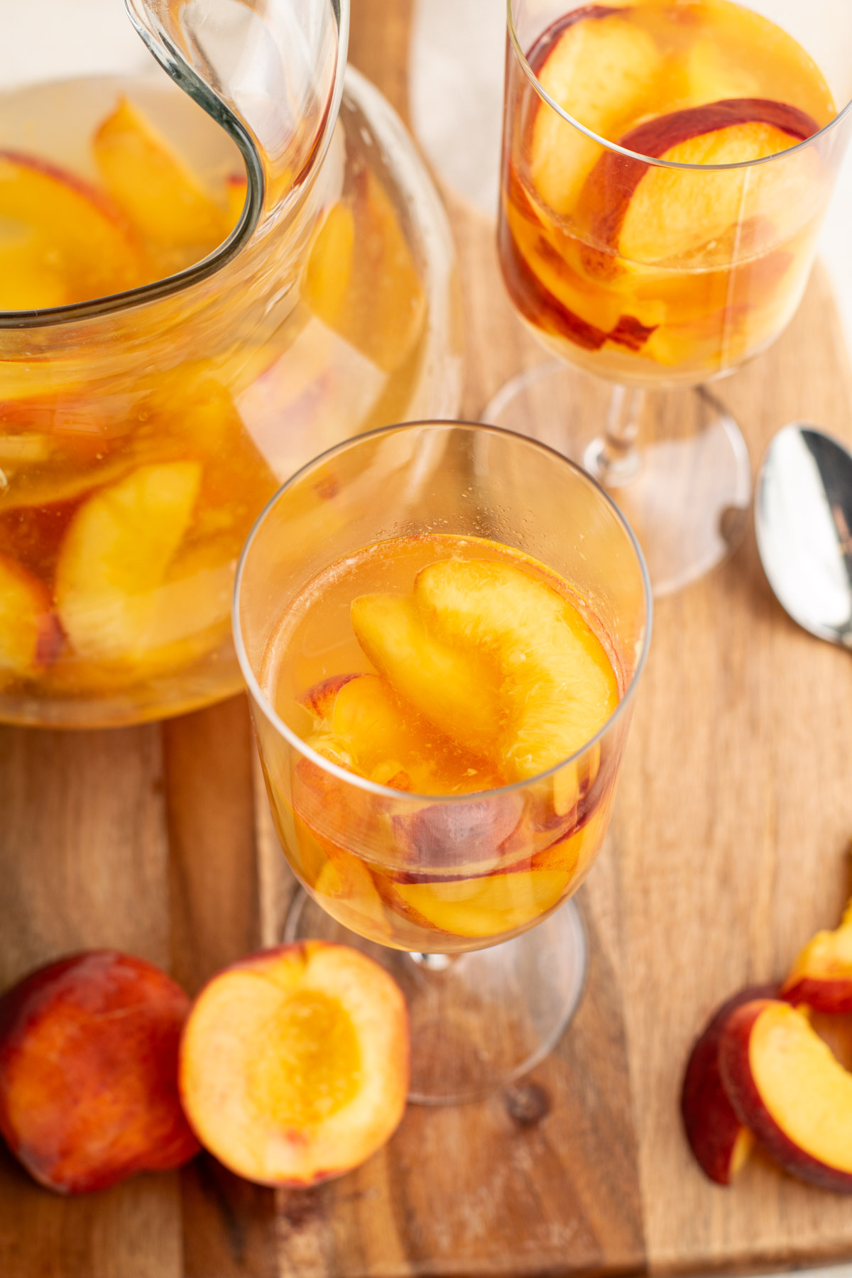 wine glasses with peaches and wine in them.