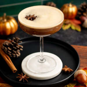 close up of a chai espresso martini with star anise on top.