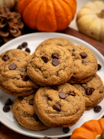 gluten free pumpkin chocolate chip cookies with mini pumpkins around.