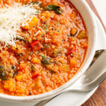 quinoa vegetable soup in a white bowl.