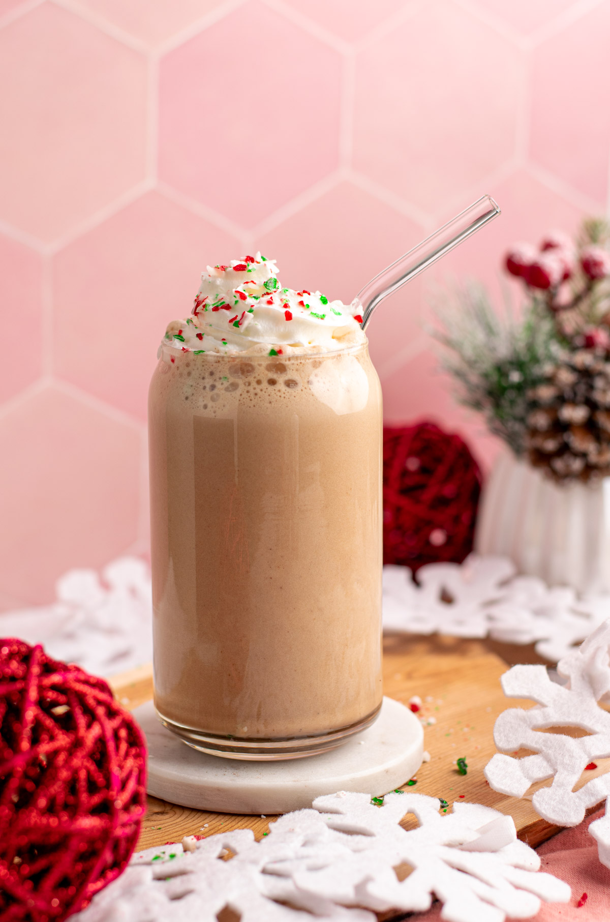 peppermint mocha protein shake in a glass with a straw.