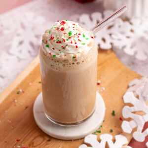 peppermint mocha protein shake with whipped cream and candy cane pieces.