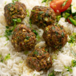 close up of beef kofta meatballs on rice.