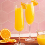 two mimosa mocktails on a wooden board.