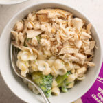 bowl of mac and cheese with added broccoli and chicken.