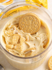 close up of golden oreos on top of protein ice cream in a ninja creami pint.