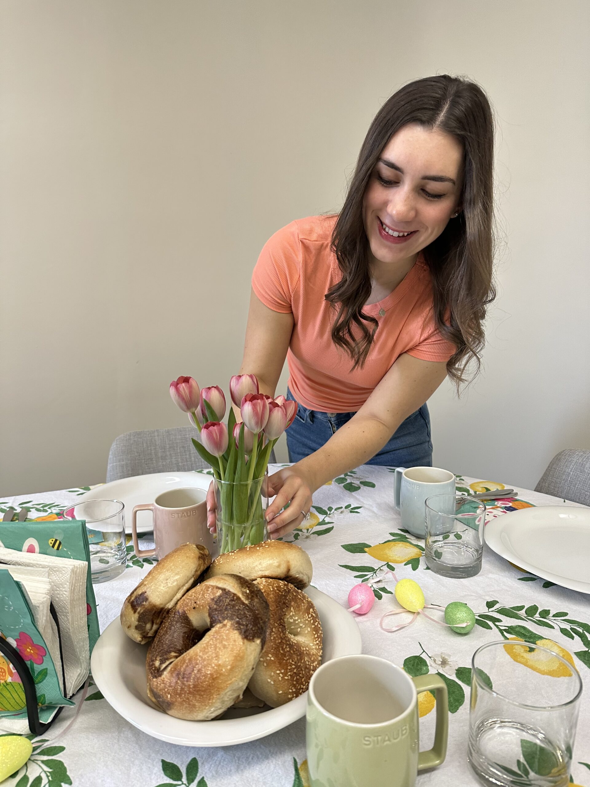 olivia arranging flowers on a table for brunch.