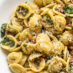orecchiette pasta with crispy salami and spinach, topped with parmesan.