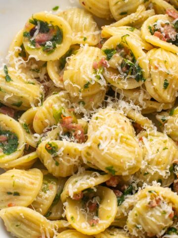 orecchiette pasta with crispy salami and spinach, topped with parmesan.