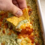 tortilla chip scooping protein spinach artichoke dip.