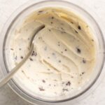 pint of protein stracciatella ice cream with a spoon.