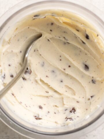 pint of protein stracciatella ice cream with a spoon.