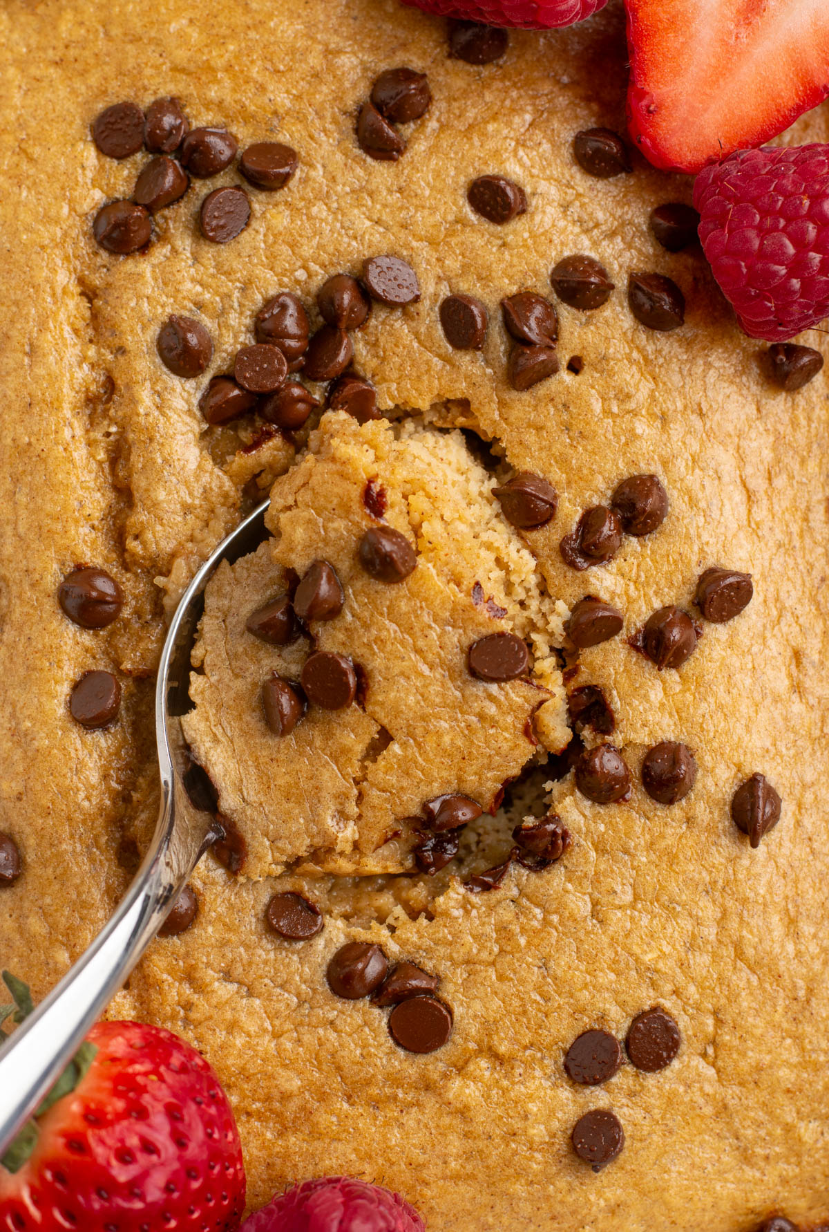 close up of a spoon scooping baked oats.