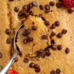 spoon scooping a bite of chocolate chip baked oats.