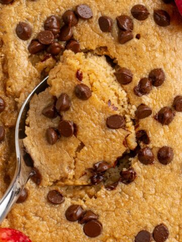 spoon scooping a bite of chocolate chip baked oats.