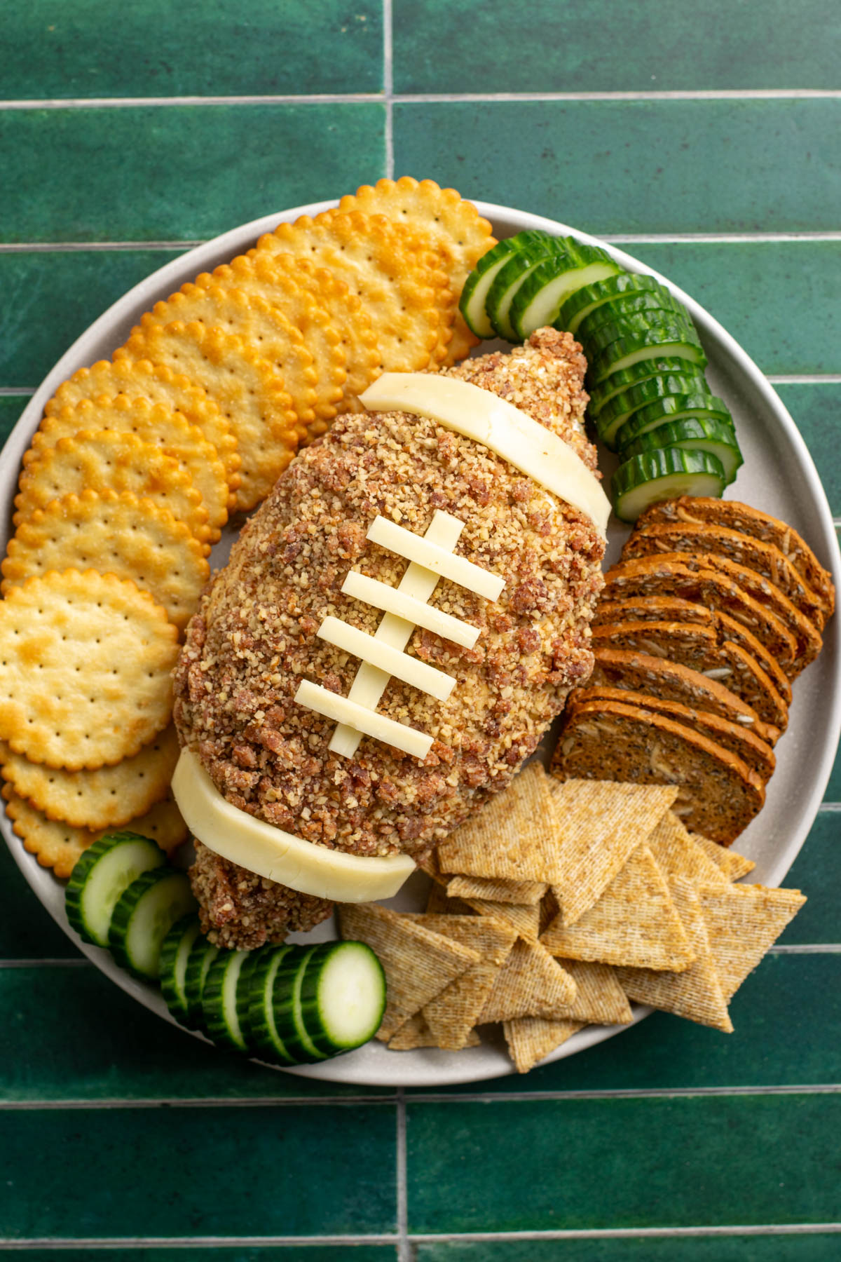 football shaped cheese ball surrounded by crackers.