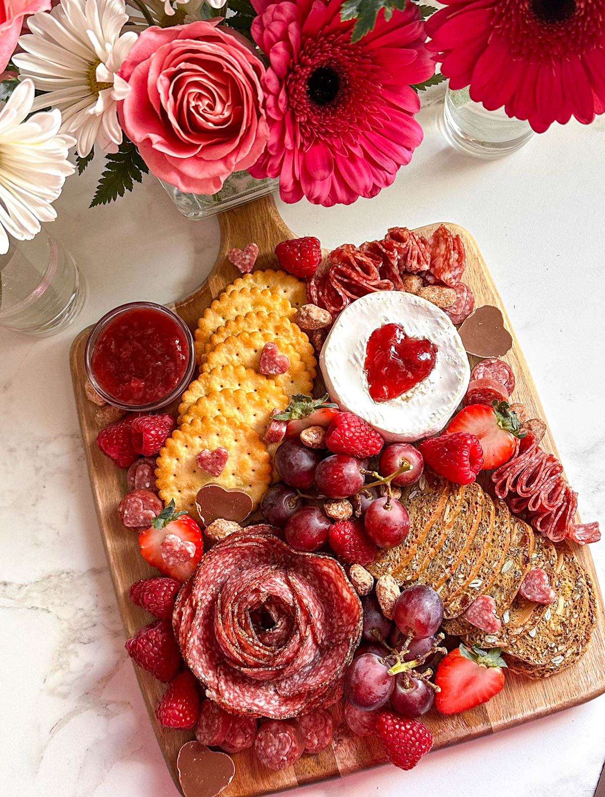 valentines charcuterie board with flowers.